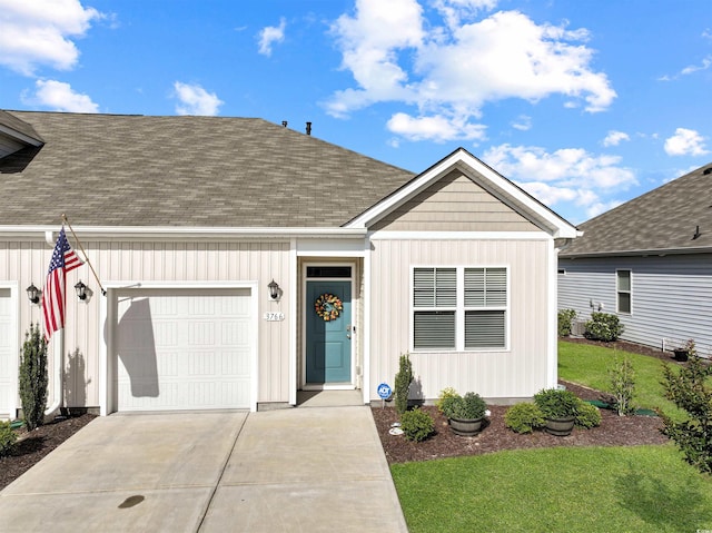 view of front of house featuring a front yard, roof with shingles, board and batten siding, an attached garage, and driveway