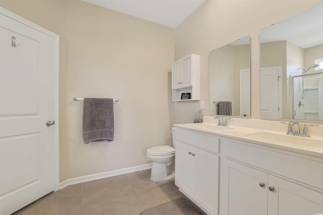 bathroom featuring baseboards, a sink, toilet, and a shower stall