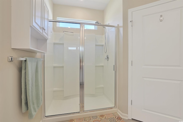 full bathroom with baseboards and a stall shower