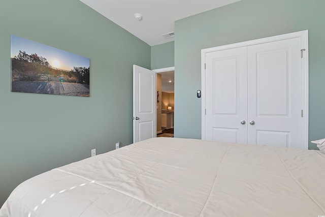 bedroom featuring visible vents and a closet