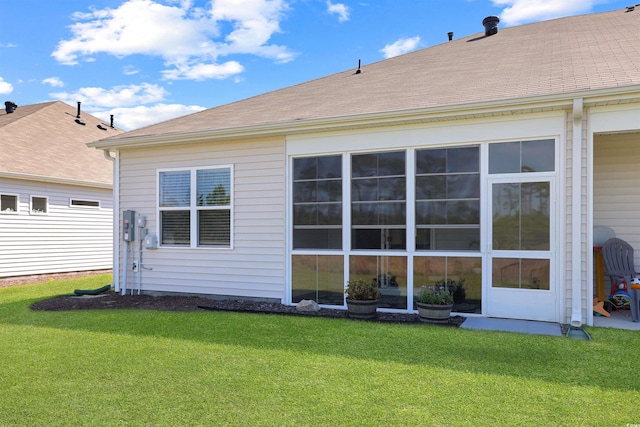 rear view of property with a lawn