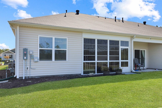 back of property featuring a yard
