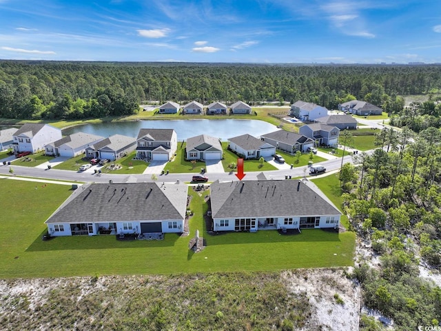birds eye view of property with a water view and a view of trees