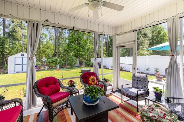 sunroom / solarium with ceiling fan and an outdoor living space