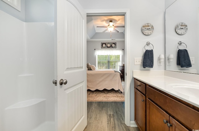 full bath featuring vanity, wood finished floors, ceiling fan, walk in shower, and connected bathroom