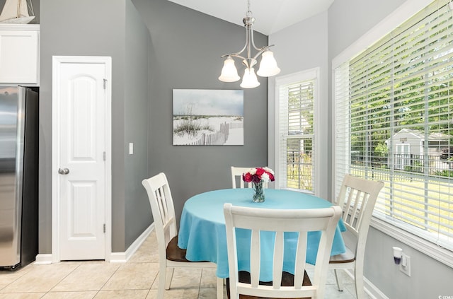 dining room featuring an inviting chandelier, baseboards, and light tile patterned flooring