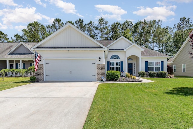 view of front of property with board and batten siding, brick siding, a front lawn, concrete driveway, and an attached garage