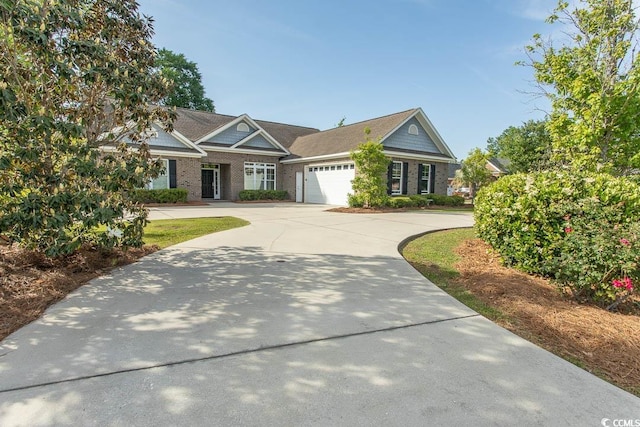 view of front facade featuring a garage, concrete driveway, and brick siding