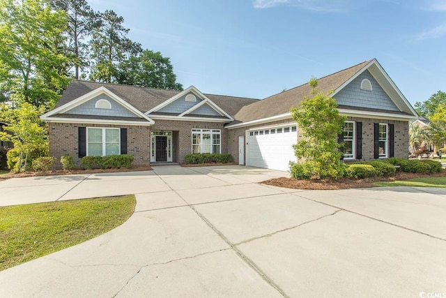 view of front of home with brick siding, an attached garage, and driveway