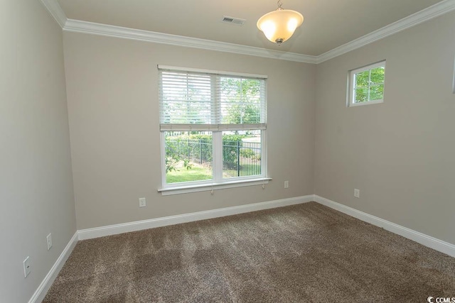 carpeted spare room featuring baseboards, ornamental molding, and visible vents