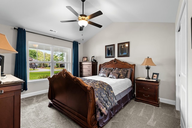 bedroom with light colored carpet, visible vents, baseboards, and lofted ceiling