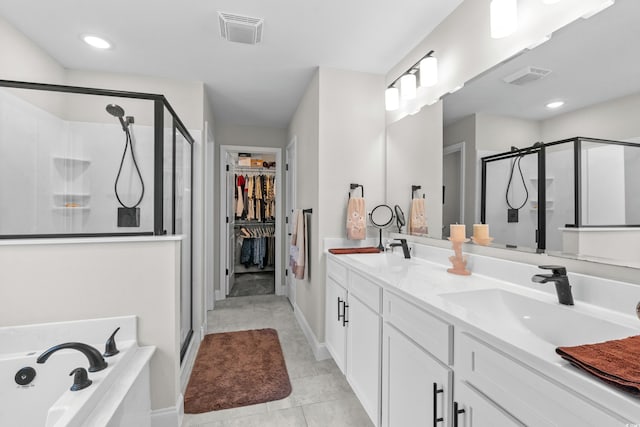 bathroom with a shower stall, visible vents, and a sink