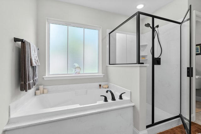 full bath with a stall shower and a garden tub