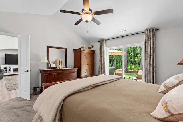 bedroom featuring ceiling fan, visible vents, vaulted ceiling, carpet floors, and access to exterior