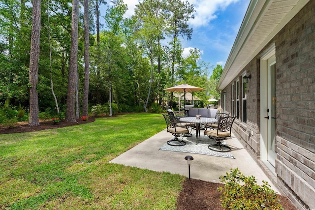 view of yard with a patio and outdoor dining area