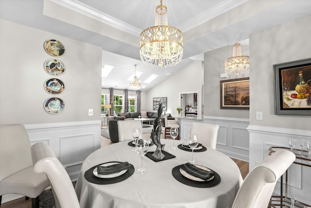 dining space with a wainscoted wall, a decorative wall, and a notable chandelier