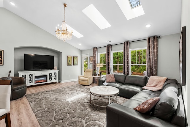 living area with recessed lighting, a chandelier, high vaulted ceiling, wood finished floors, and a skylight