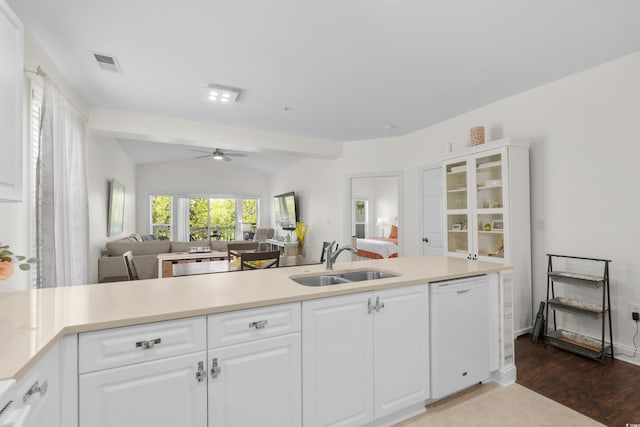 kitchen with white dishwasher, ceiling fan, a sink, open floor plan, and visible vents