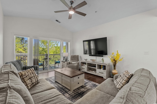 living area featuring visible vents, ceiling fan, vaulted ceiling, and dark wood-style floors
