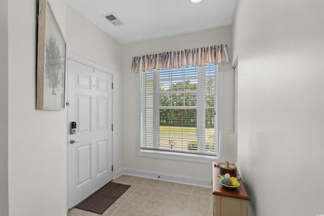 entrance foyer with baseboards, plenty of natural light, and visible vents