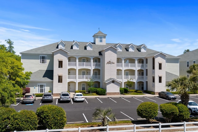 view of building exterior with uncovered parking