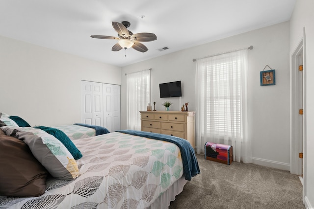 bedroom featuring visible vents, carpet floors, a closet, baseboards, and a ceiling fan
