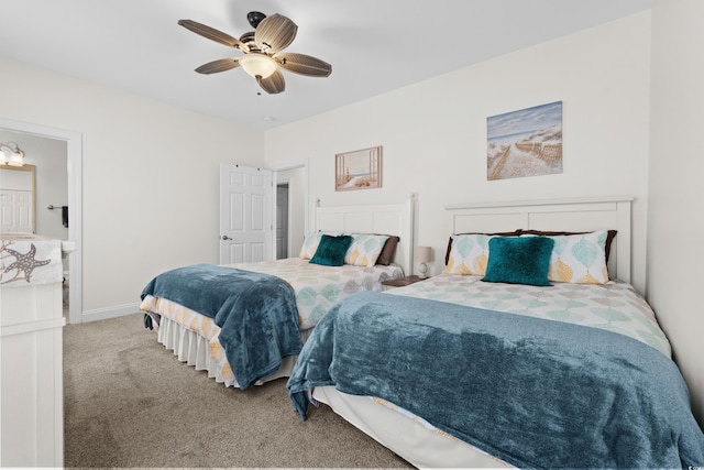 carpeted bedroom with baseboards, ceiling fan, and ensuite bath
