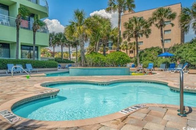 community pool featuring a patio area