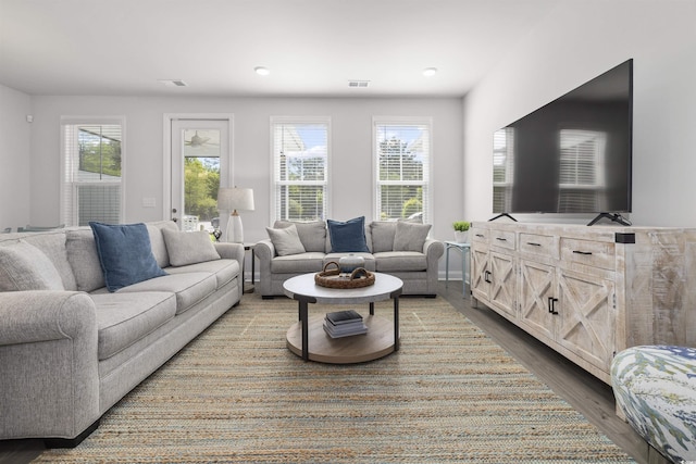 living room featuring recessed lighting, visible vents, and wood finished floors