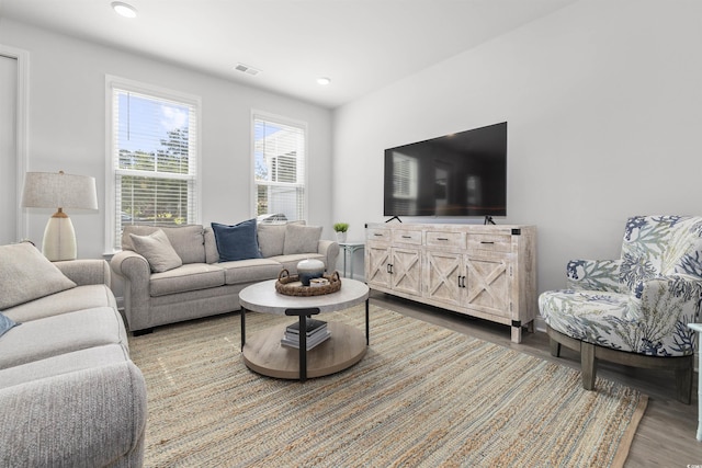 living area featuring recessed lighting, wood finished floors, and visible vents