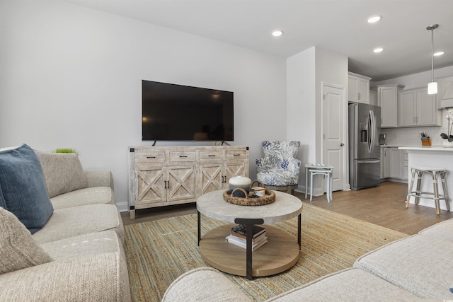 living room featuring light wood-style floors and recessed lighting