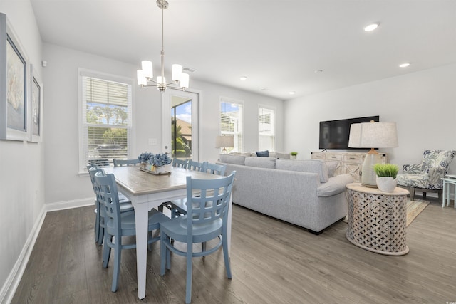 dining area with visible vents, wood finished floors, baseboards, an inviting chandelier, and recessed lighting
