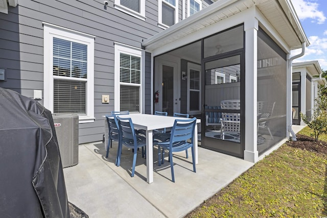 view of patio / terrace with cooling unit, outdoor dining area, and a sunroom