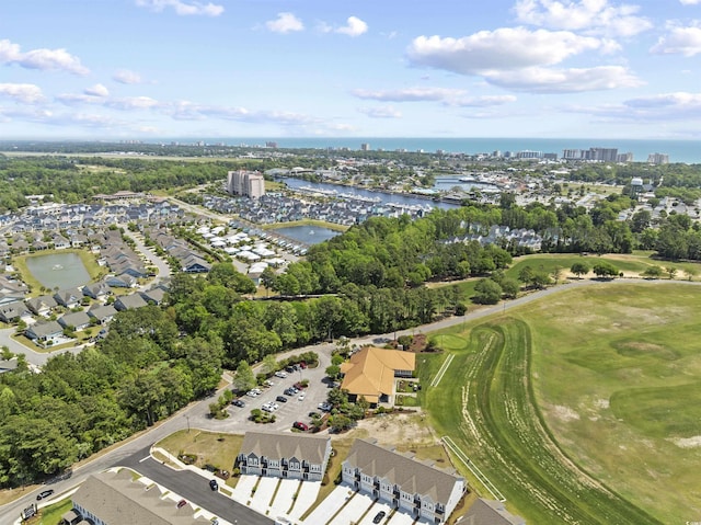 birds eye view of property featuring view of golf course and a water view