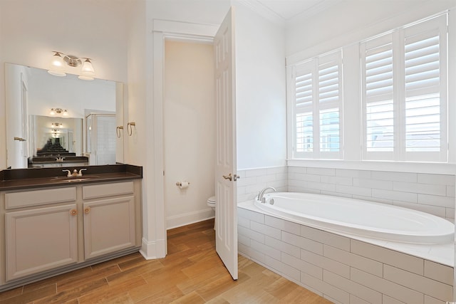1359 Peterson St, Myrtle Beach, SC 29577 - full bathroom featuring toilet, a garden tub, vanity, crown molding, and wood finished floors