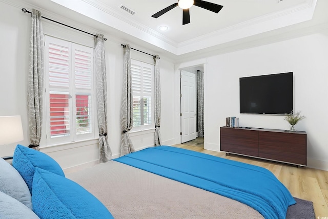 1359 Peterson St, Myrtle Beach, SC 29577 - bedroom with ornamental molding, wood finished floors, baseboards, ceiling fan, and a tray ceiling
