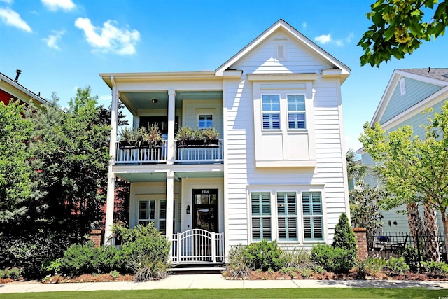 1359 Peterson St, Myrtle Beach, SC 29577 - neoclassical / greek revival house with a balcony, fence, and covered porch