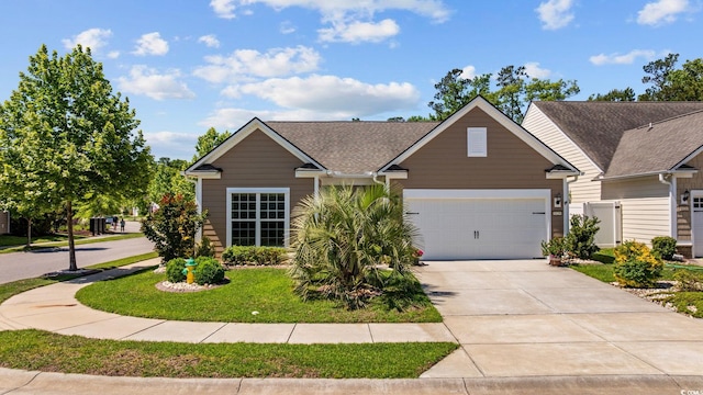 view of front of house with an attached garage, driveway, and roof with shingles