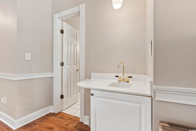 4771 Wild Iris Dr Unit 103, Myrtle Beach, SC 29577 - bathroom with vanity, baseboards, and wood finished floors