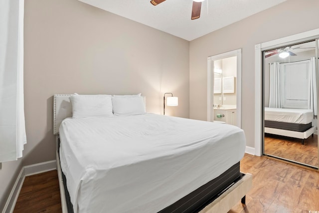 4771 Wild Iris Dr Unit 103, Myrtle Beach, SC 29577 - bedroom with baseboards, a ceiling fan, light wood-type flooring, and ensuite bath