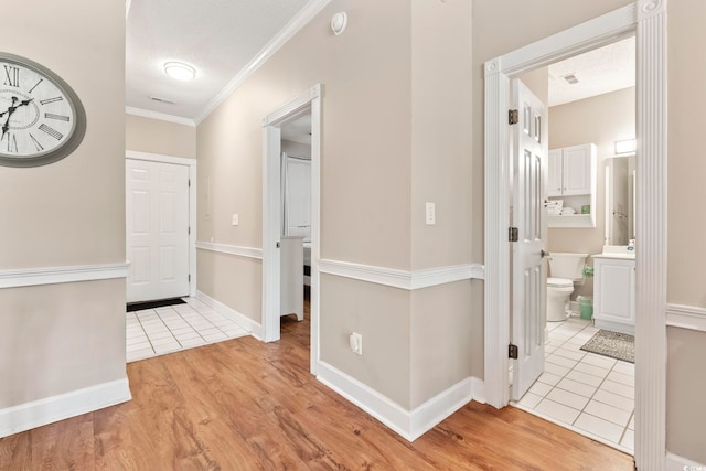4771 Wild Iris Dr Unit 103, Myrtle Beach, SC 29577 - hallway with crown molding, light tile patterned flooring, baseboards, and visible vents