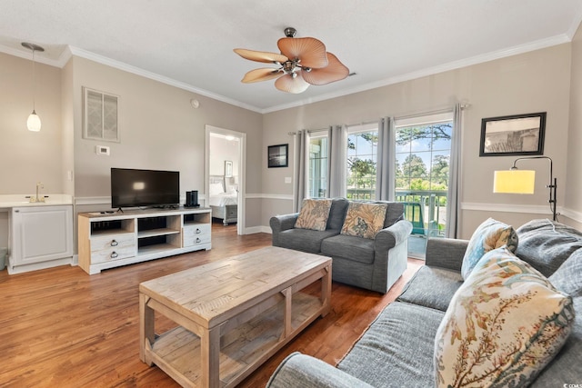 4771 Wild Iris Dr Unit 103, Myrtle Beach, SC 29577 - living room featuring visible vents, a ceiling fan, light wood-style floors, and crown molding