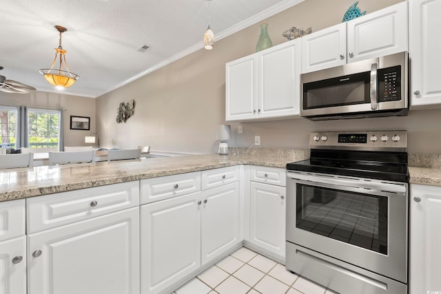 4771 Wild Iris Dr Unit 103, Myrtle Beach, SC 29577 - kitchen featuring crown molding, hanging light fixtures, appliances with stainless steel finishes, and white cabinetry