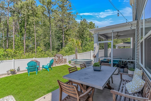 view of patio with a fenced backyard, ceiling fan, a jacuzzi, and outdoor dining space