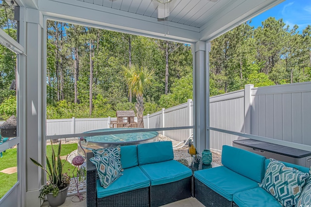 sunroom with ceiling fan, outdoor lounge area, and plenty of natural light