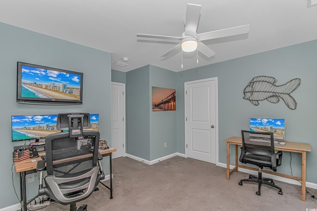 home office featuring baseboards, ceiling fan, and carpet