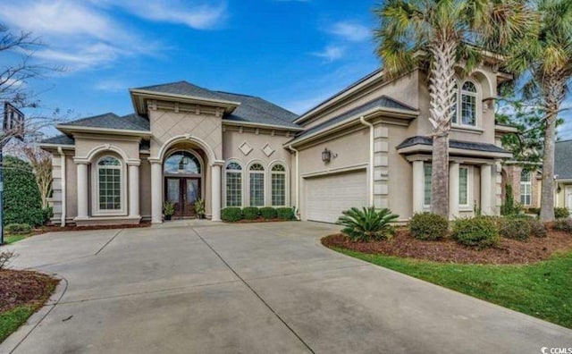 9060 Abingdon Dr, Myrtle Beach, SC 29579 - mediterranean / spanish house featuring an attached garage, driveway, french doors, and stucco siding
