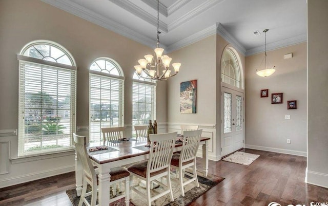 9060 Abingdon Dr, Myrtle Beach, SC 29579 - dining space with a notable chandelier, ornamental molding, a healthy amount of sunlight, and wood finished floors