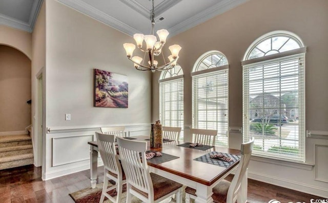 9060 Abingdon Dr, Myrtle Beach, SC 29579 - dining space with ornamental molding, a notable chandelier, wood finished floors, and a healthy amount of sunlight