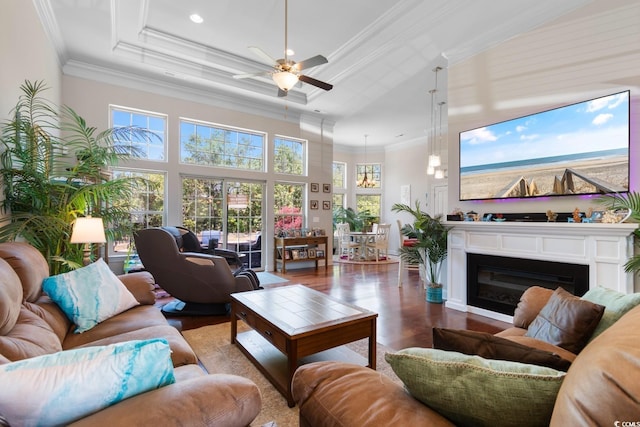 9060 Abingdon Dr, Myrtle Beach, SC 29579 - living area with ornamental molding, a glass covered fireplace, wood finished floors, a raised ceiling, and a ceiling fan